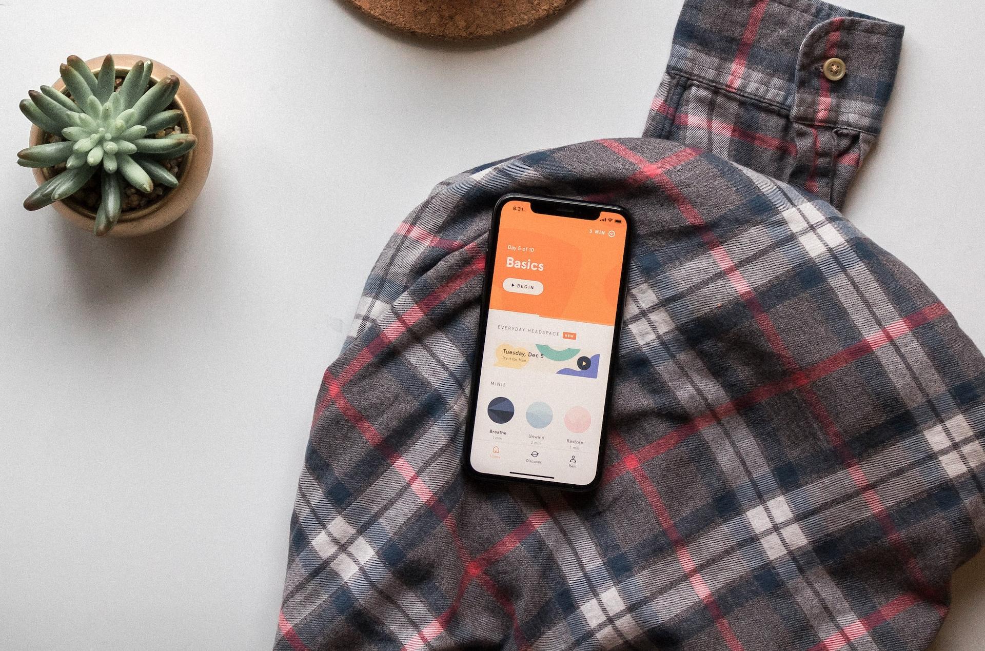 black smartphone on long-sleeved shirt